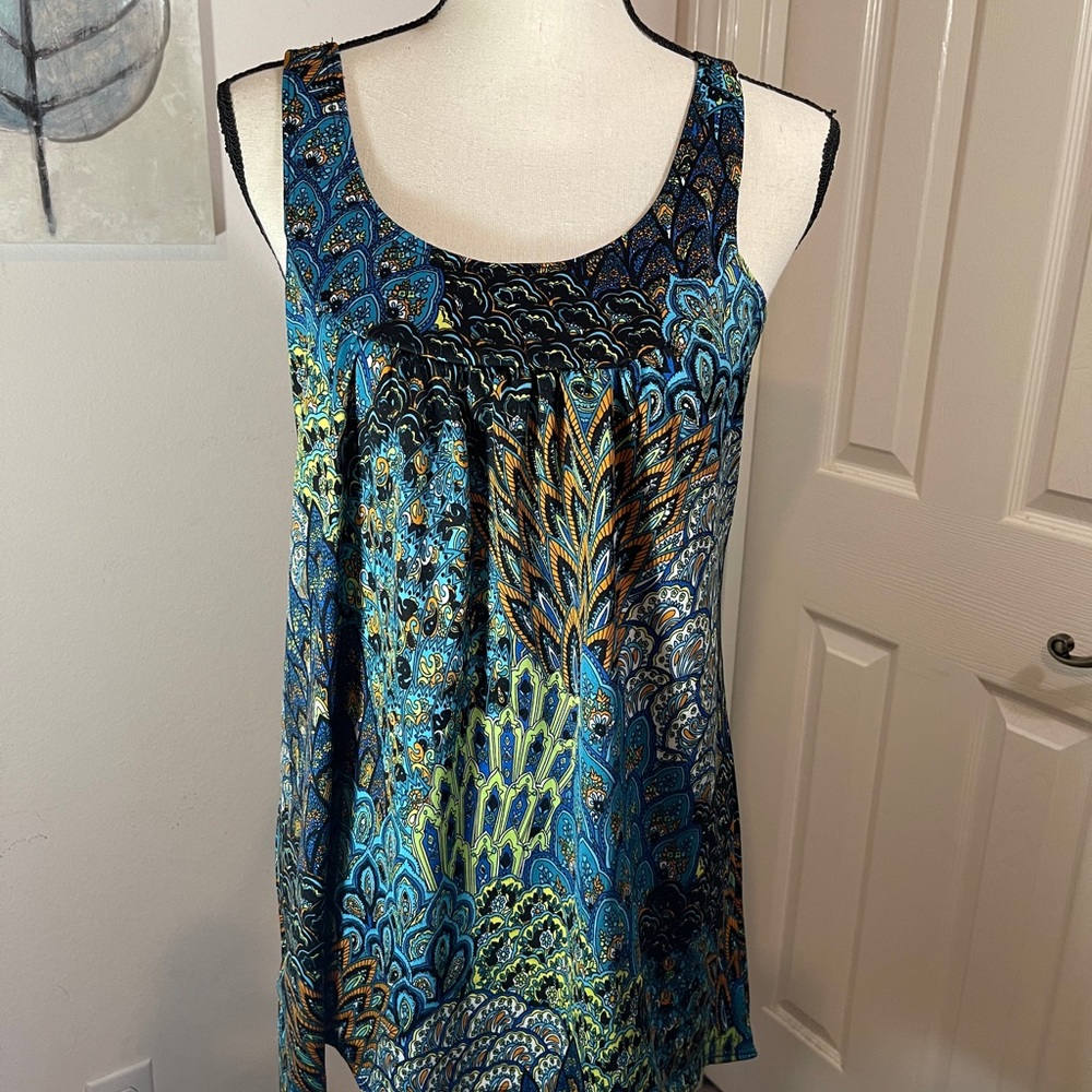 Peacock print sleeveless blouse vibrant colors